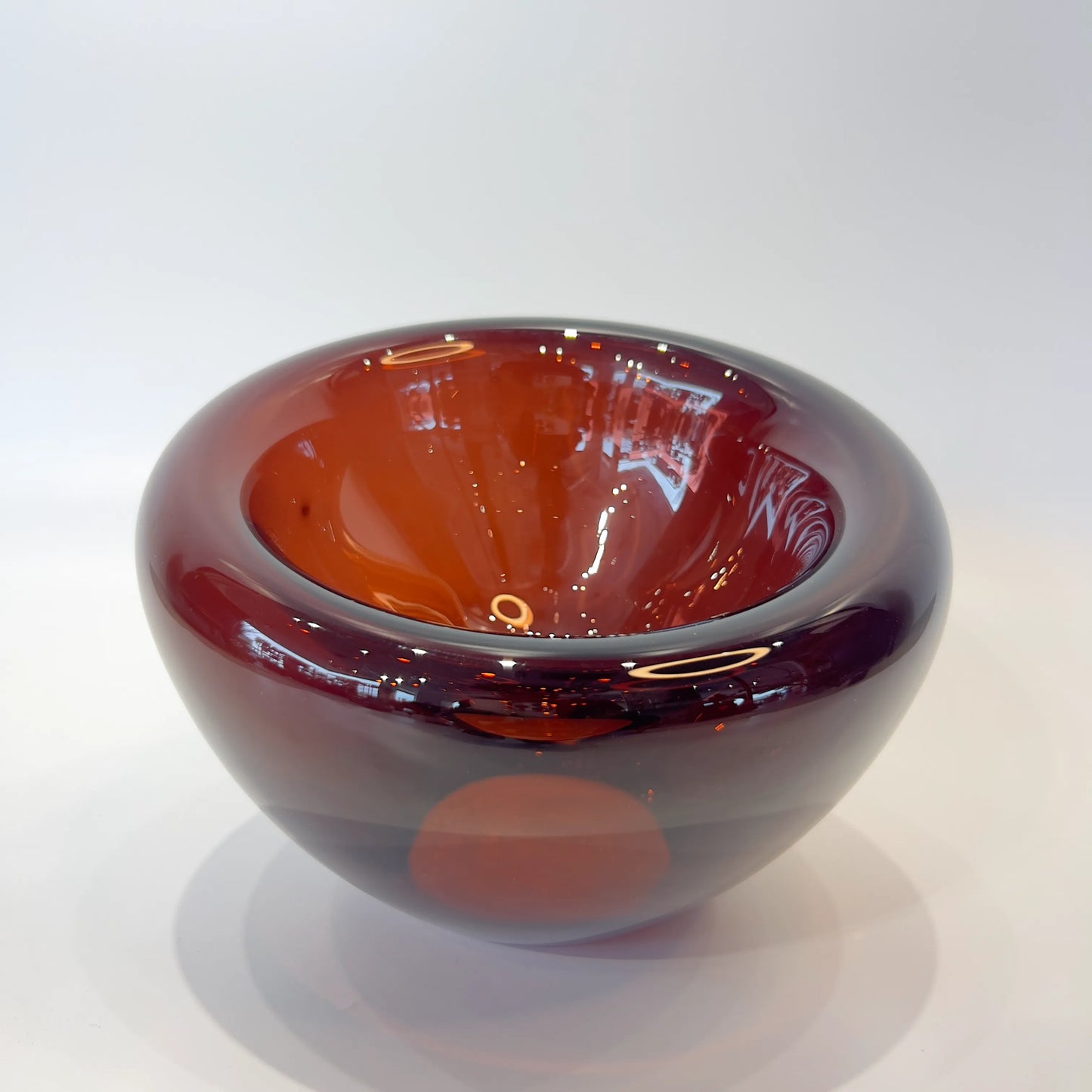 Glass bowl with red and purple gradient on a white background