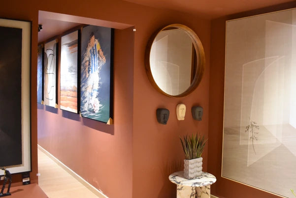 FabCuro home decor store in Kasturi Nagar, Bangalore, with a curated display of home decor items including abstract wall art, a round wall mirror, decorative masks, a marble-top side table, and indoor plants.